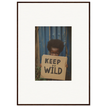 Framed photograph of a person with a KEEP IT WILD sign for room decoration