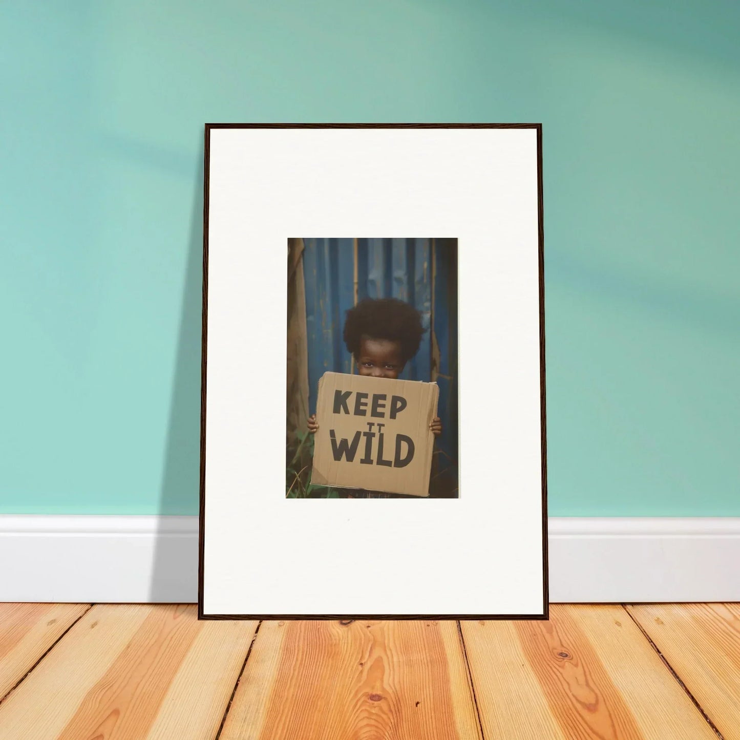 Framed canvas print of a photo holding a KEEP IT WILD sign for room decoration