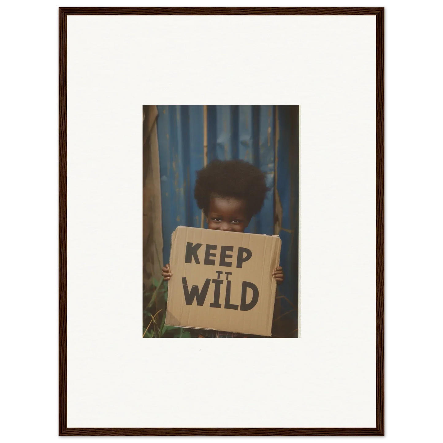 Framed photograph of person with KEEP IT WILD sign, perfect for room decoration or canvas print