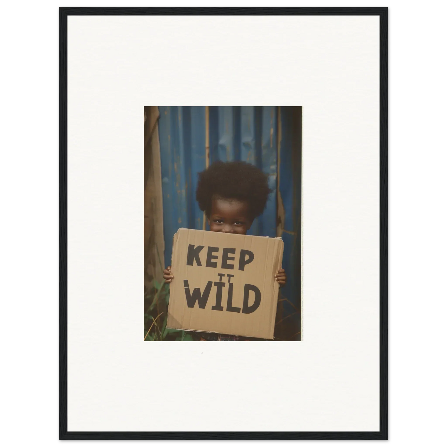 Framed photograph of person with KEEP IT WILD sign, perfect for innocent harmony room decoration