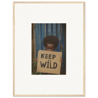 Framed canvas print of a person with a Keep It Wild sign for room decoration