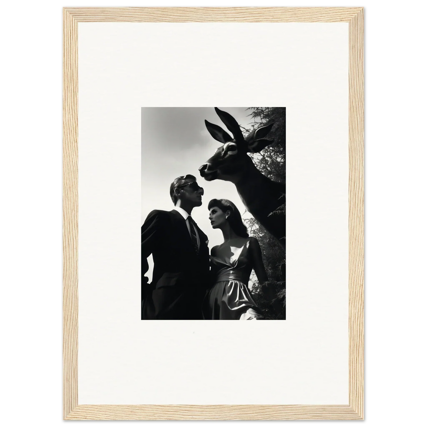 Black and white photograph of a couple with a large rabbit sculpture.