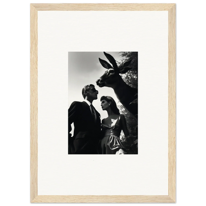 Black and white photograph of a couple with a large rabbit sculpture.