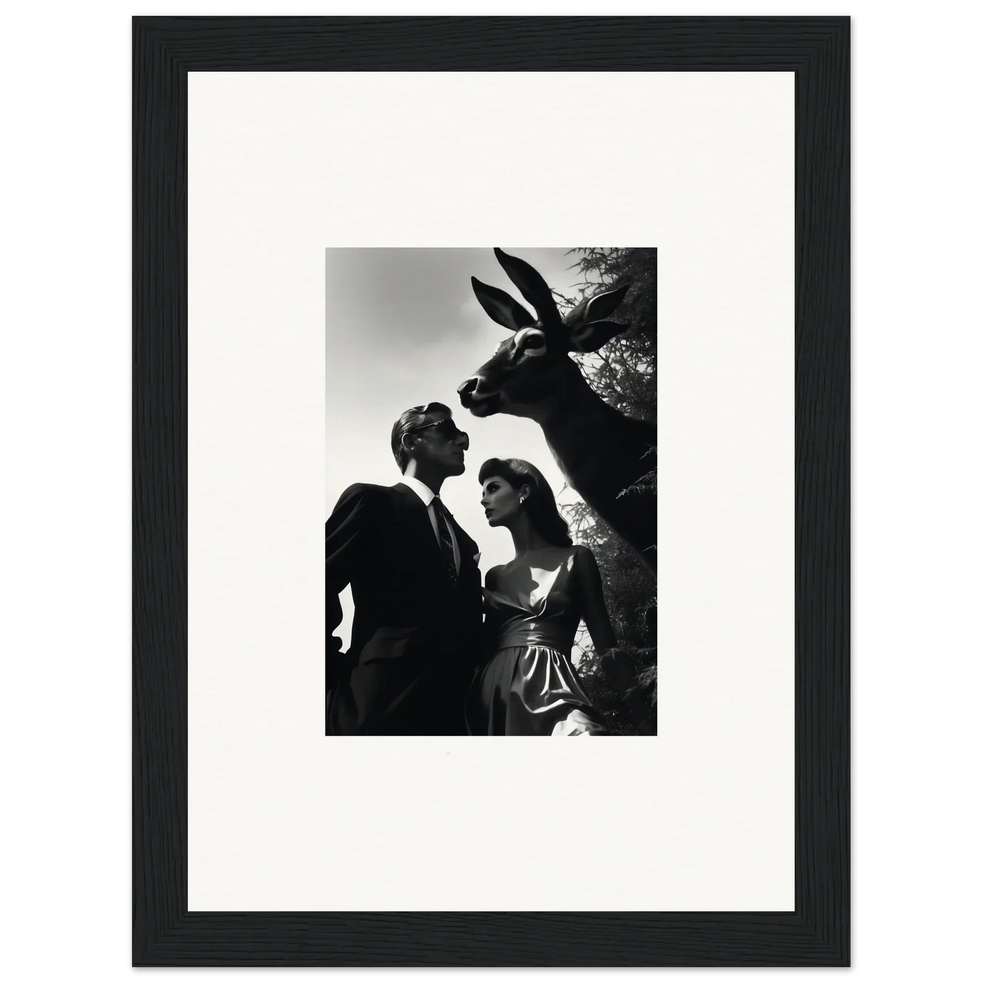 Black and white photograph of a couple with a large rabbit or hare figure looming over them.