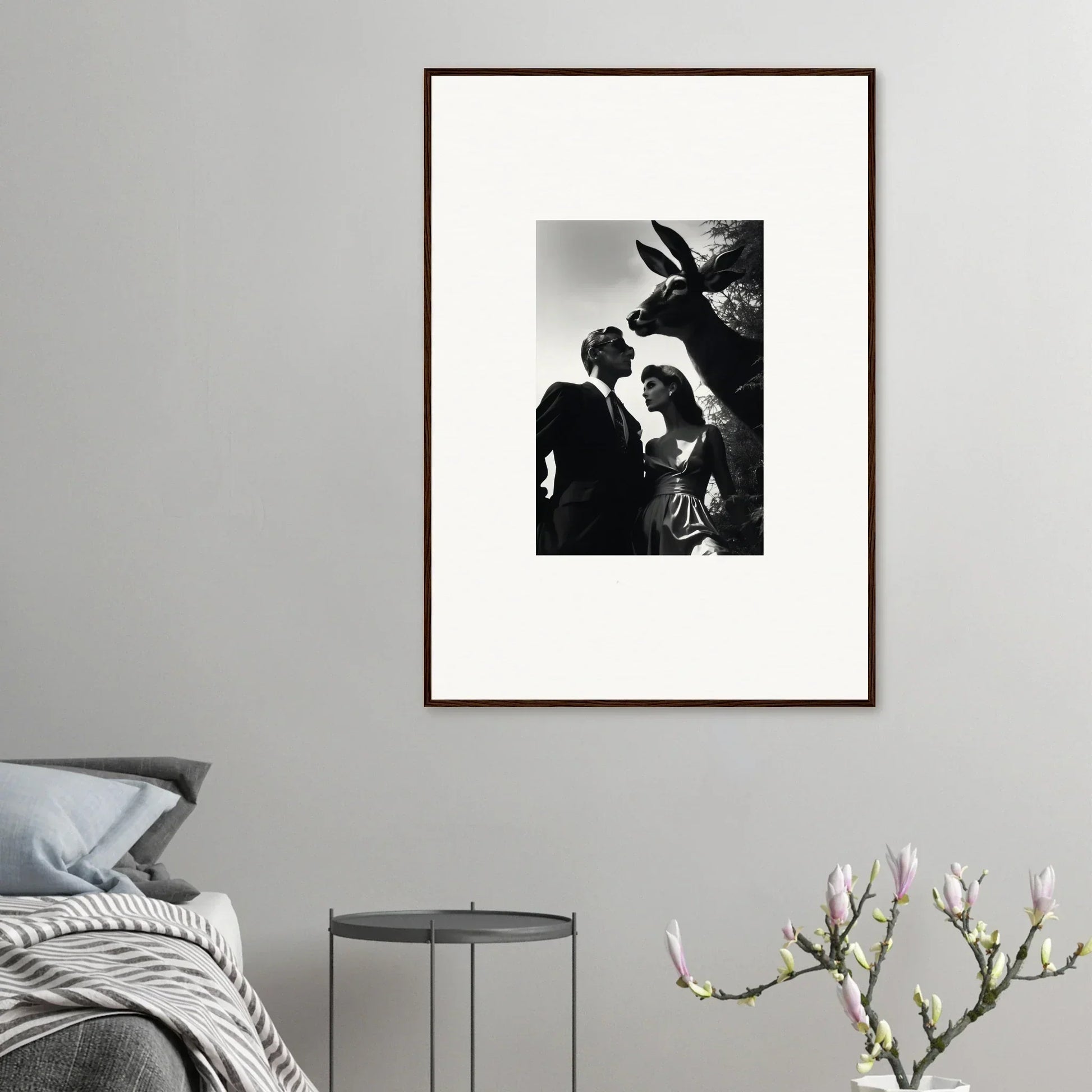 Framed black and white photograph showing silhouettes of two people and a bird.