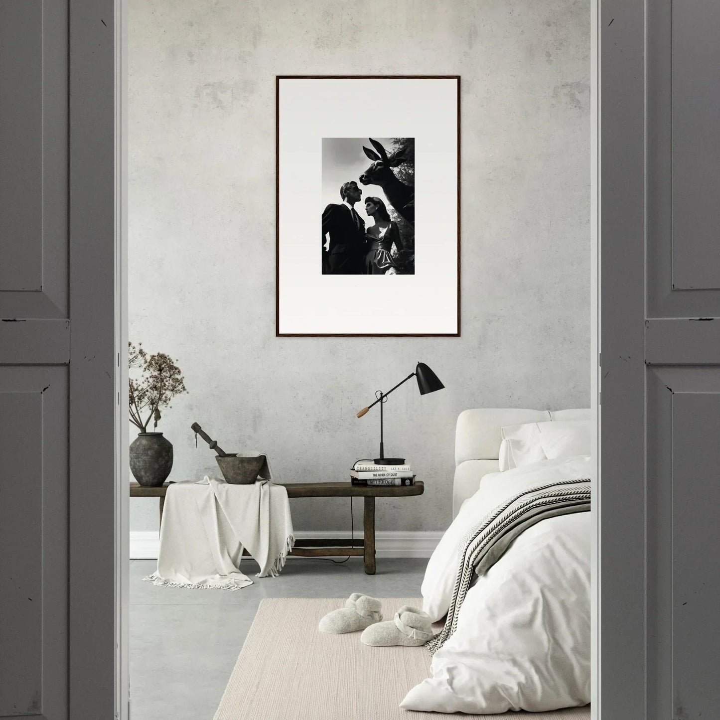 Minimalist bedroom with a framed black and white photograph as the focal point.