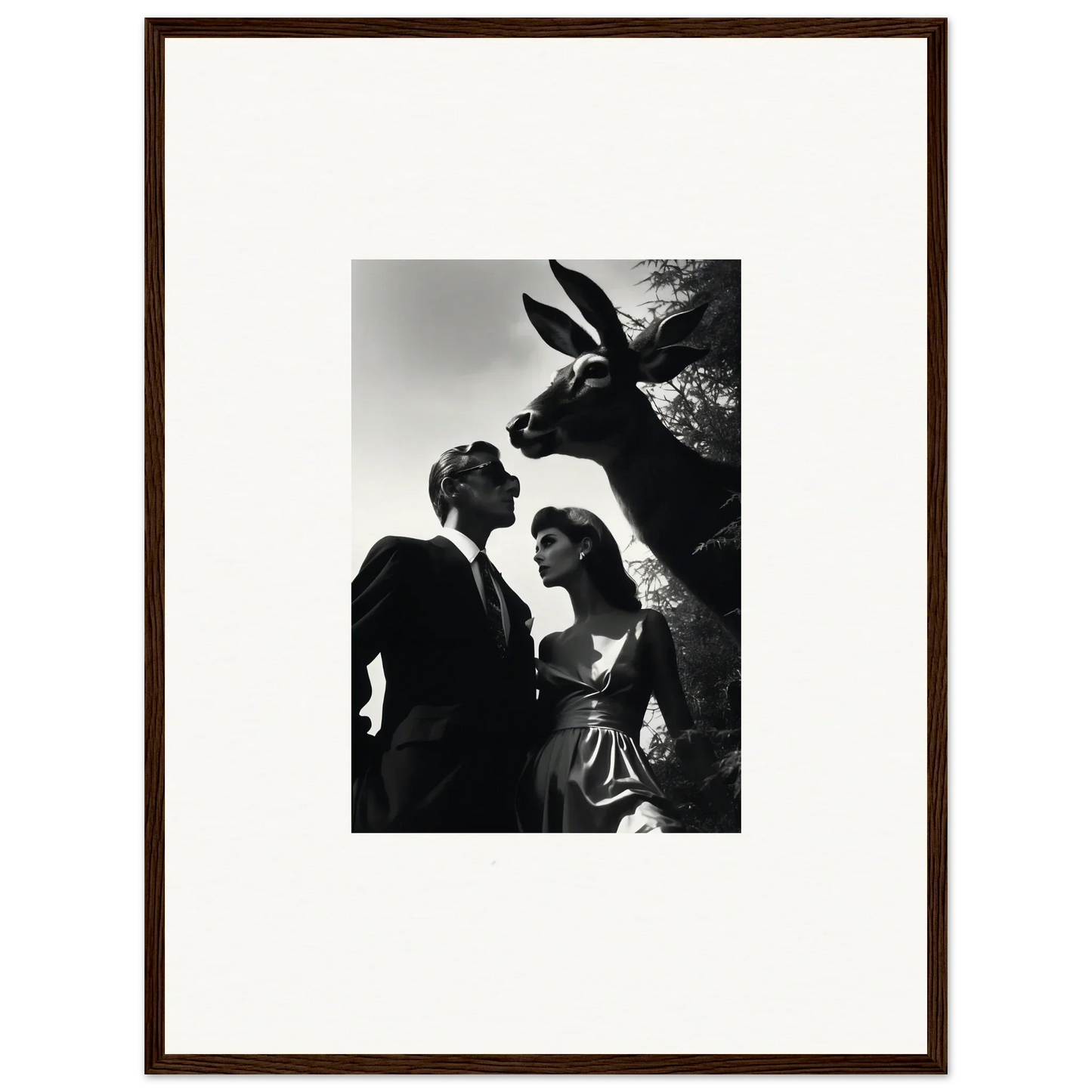 Black and white photograph of a couple with a large rabbit head looming above them.