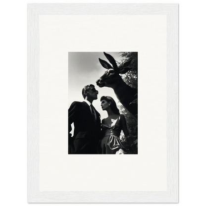 Black and white photograph of a couple with a large animal head looming above them.