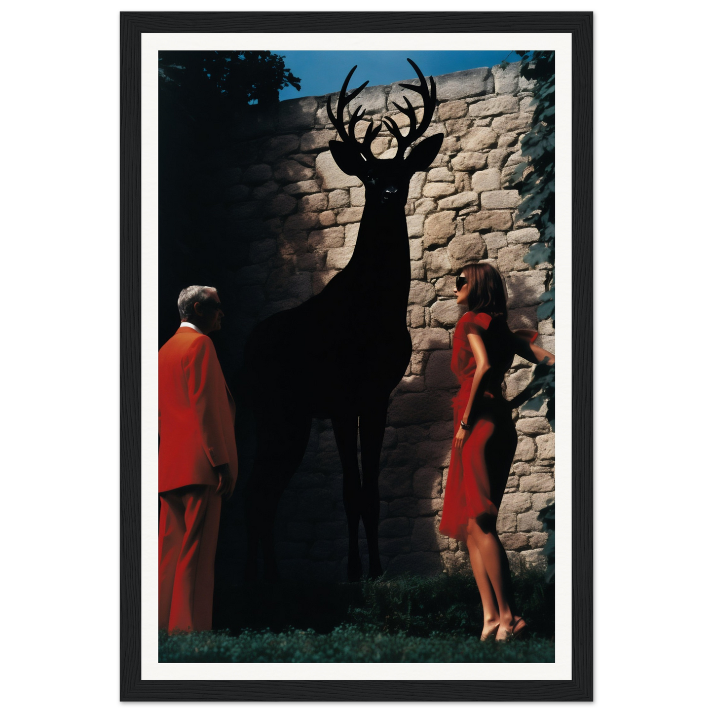 A framed print of a deer and two women in red dresses