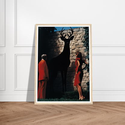 A framed print of a deer and a woman in red dress