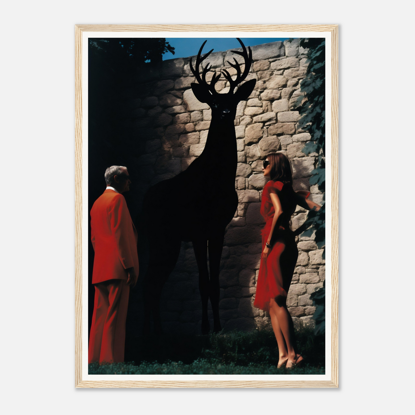 A framed print of a deer and a woman in red dress