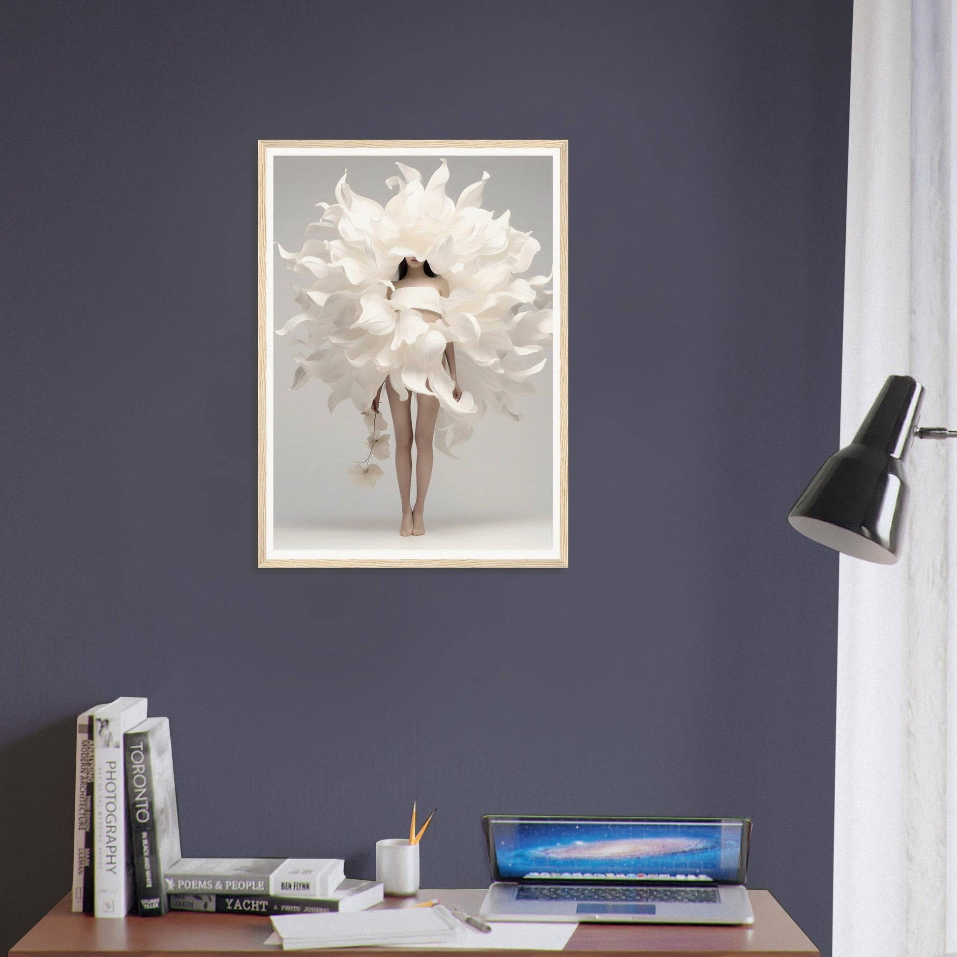 A framed print of a white flower on a desk