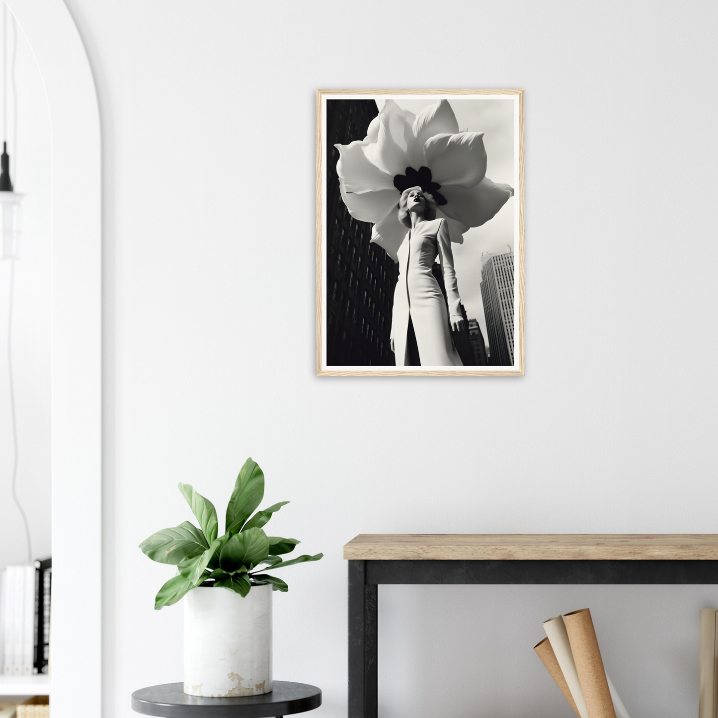 A framed print of a white flower on a white wall