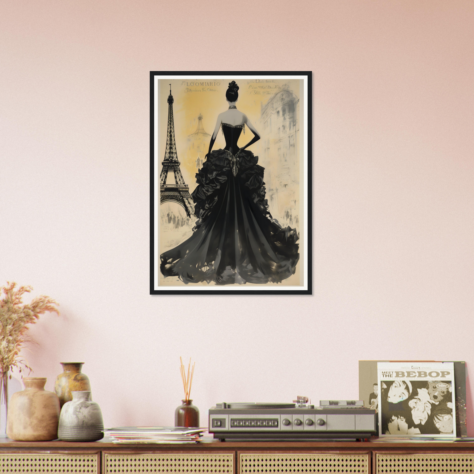 A framed print of a woman in a black dress with the eiff tower in the background