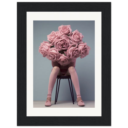 A framed print of a woman sitting on a chair with pink roses