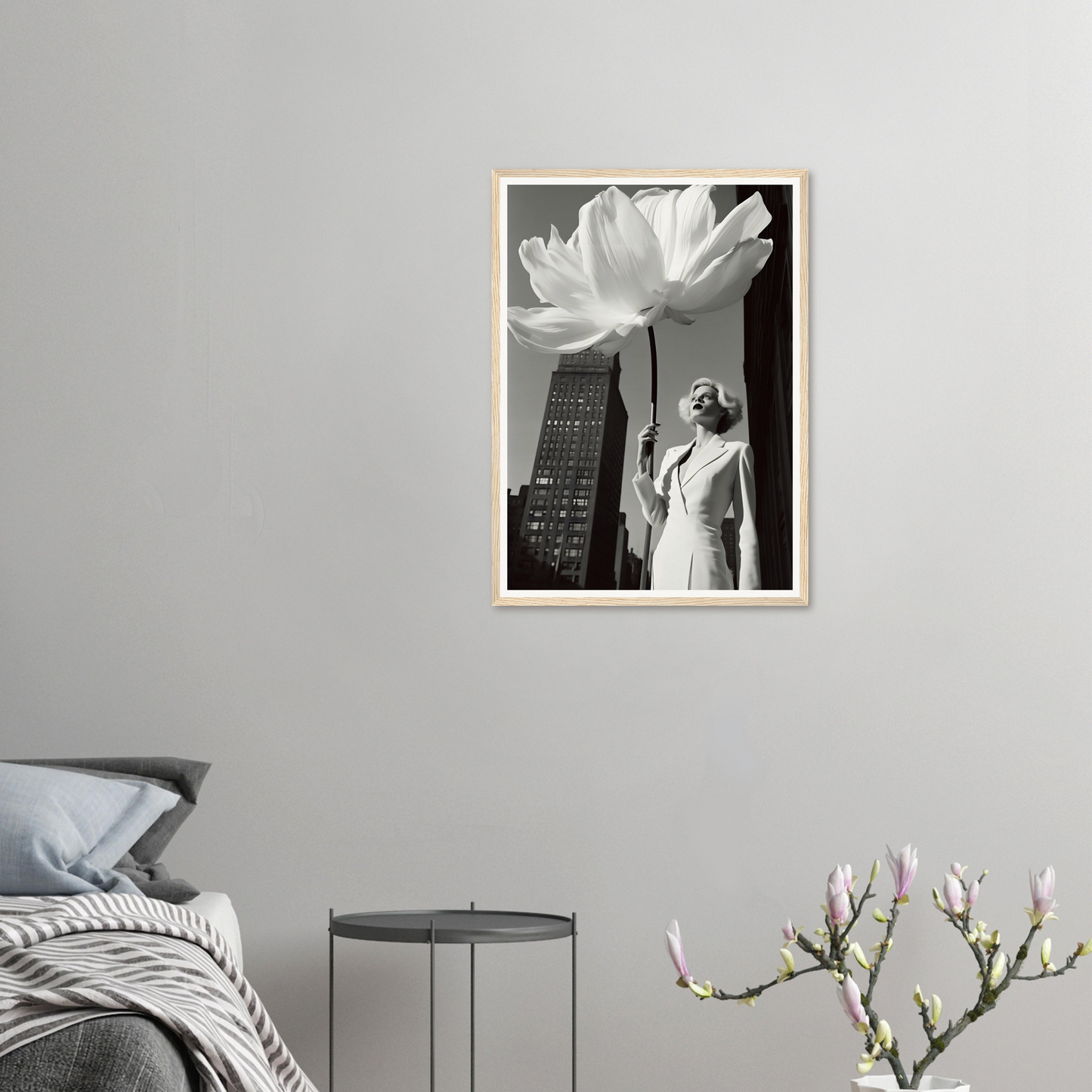 A framed print of a woman standing in front of a large white flower