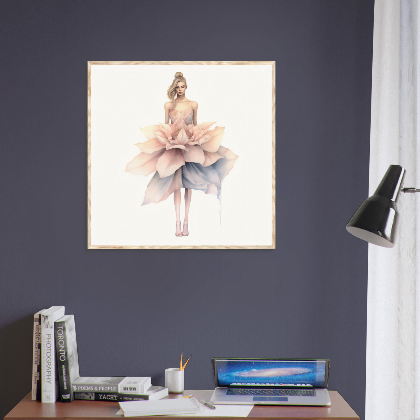 A framed print of a woman in a pink dress on a desk