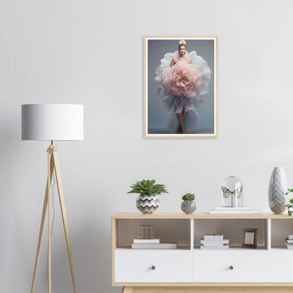 A framed print of a woman in a pink dress with a flower in her hair