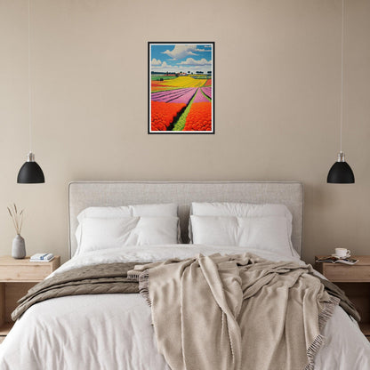 Framed colorful landscape painting of tulip fields hanging above a bed.