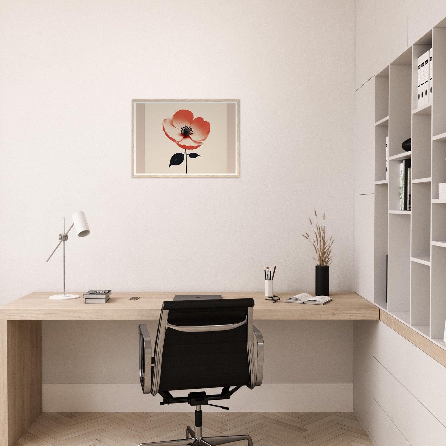 Minimalist home office workspace with a wooden desk, black chair, and floral wall art.