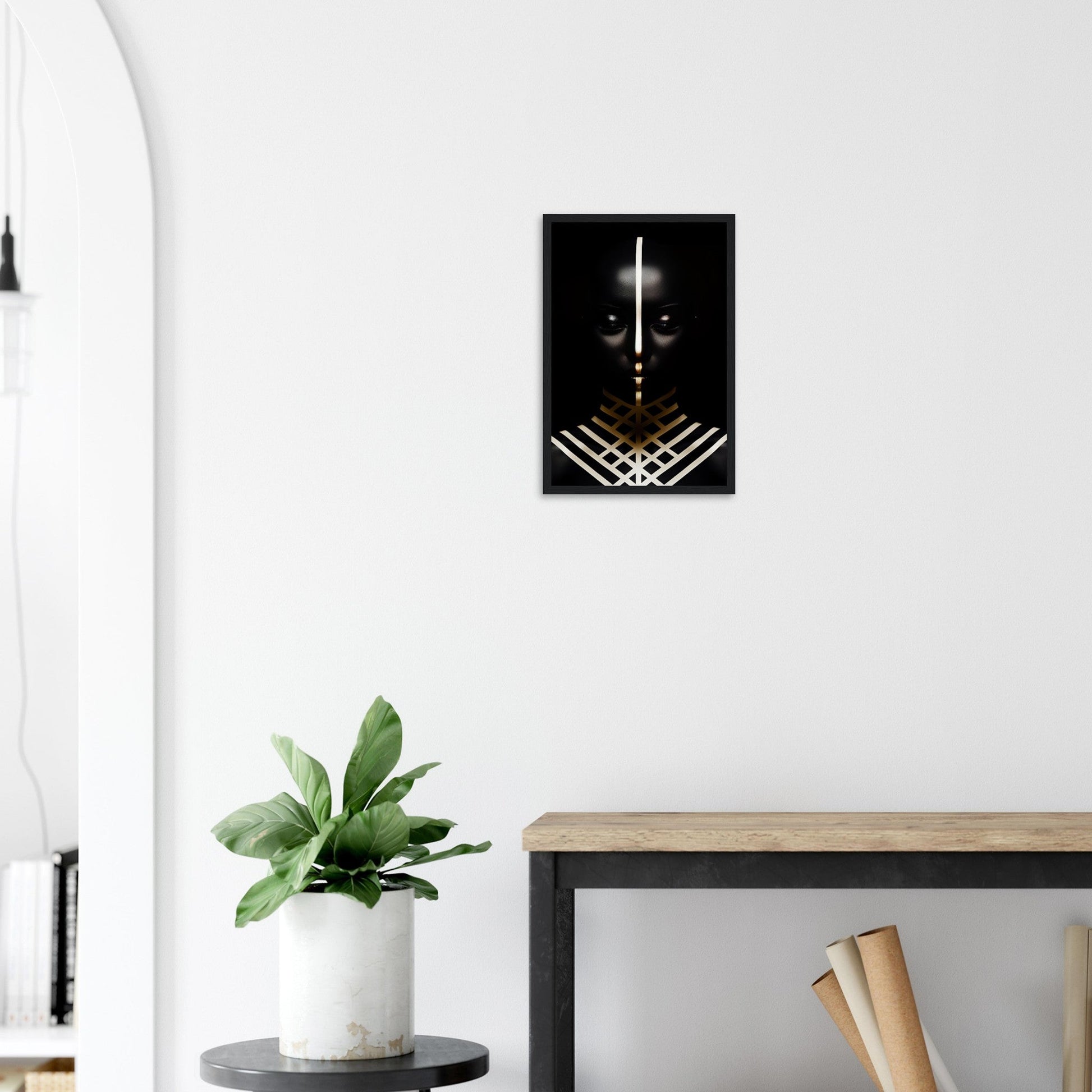 Framed black and gold artwork depicting an abstract face with geometric elements.