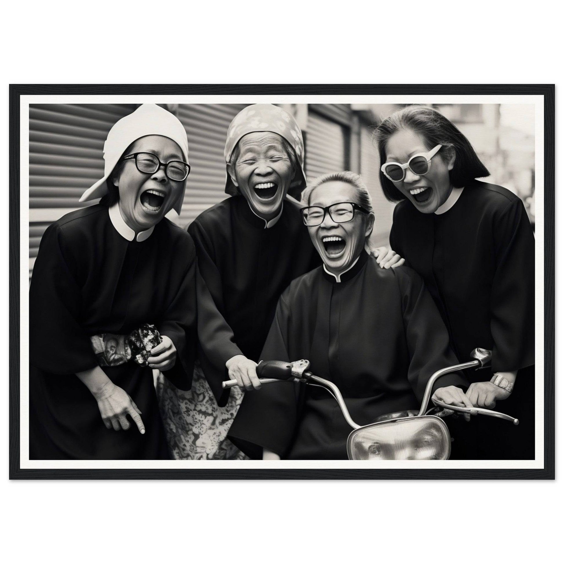 Black and white photograph of four joyful nuns laughing together.