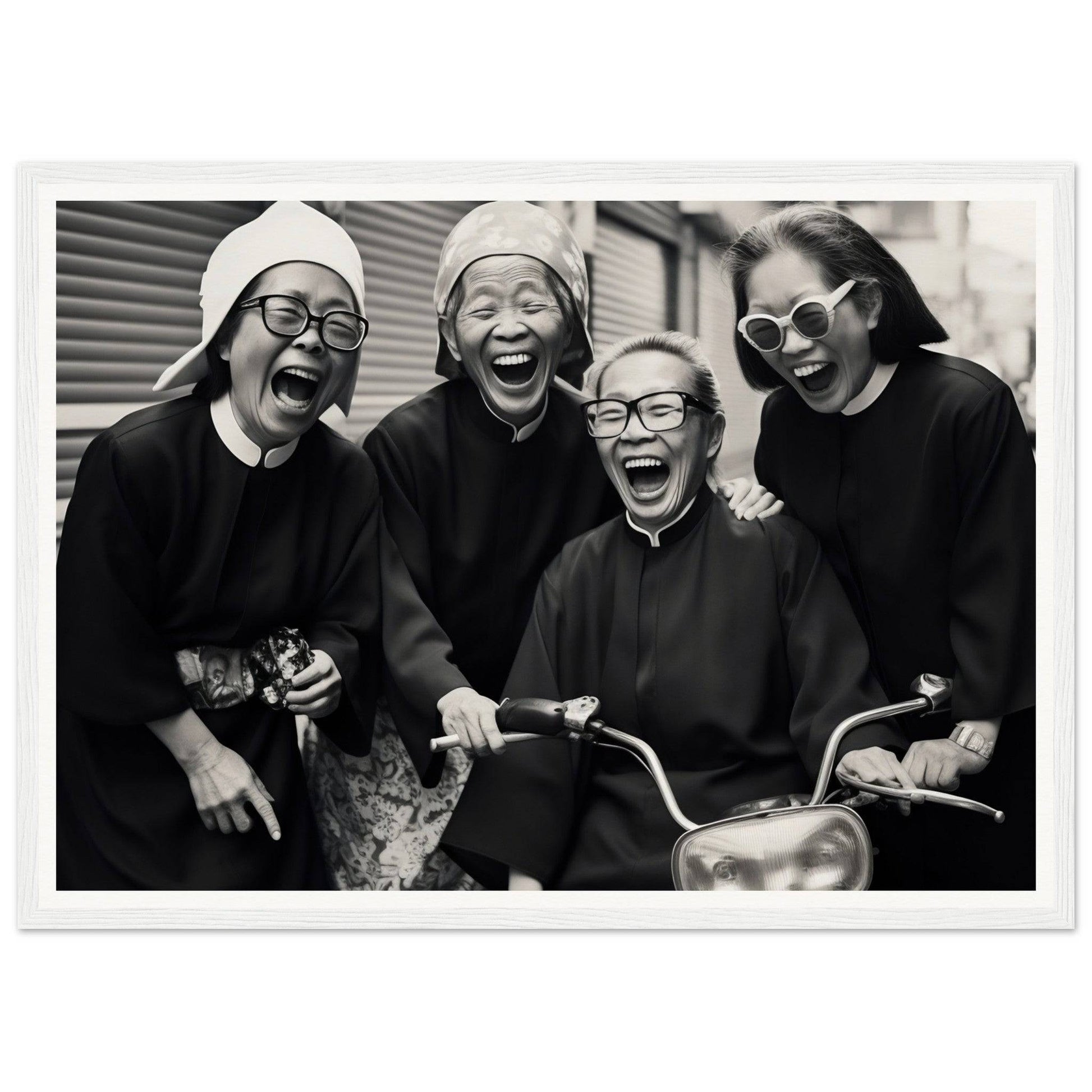 Black and white photograph of four joyful women laughing together.