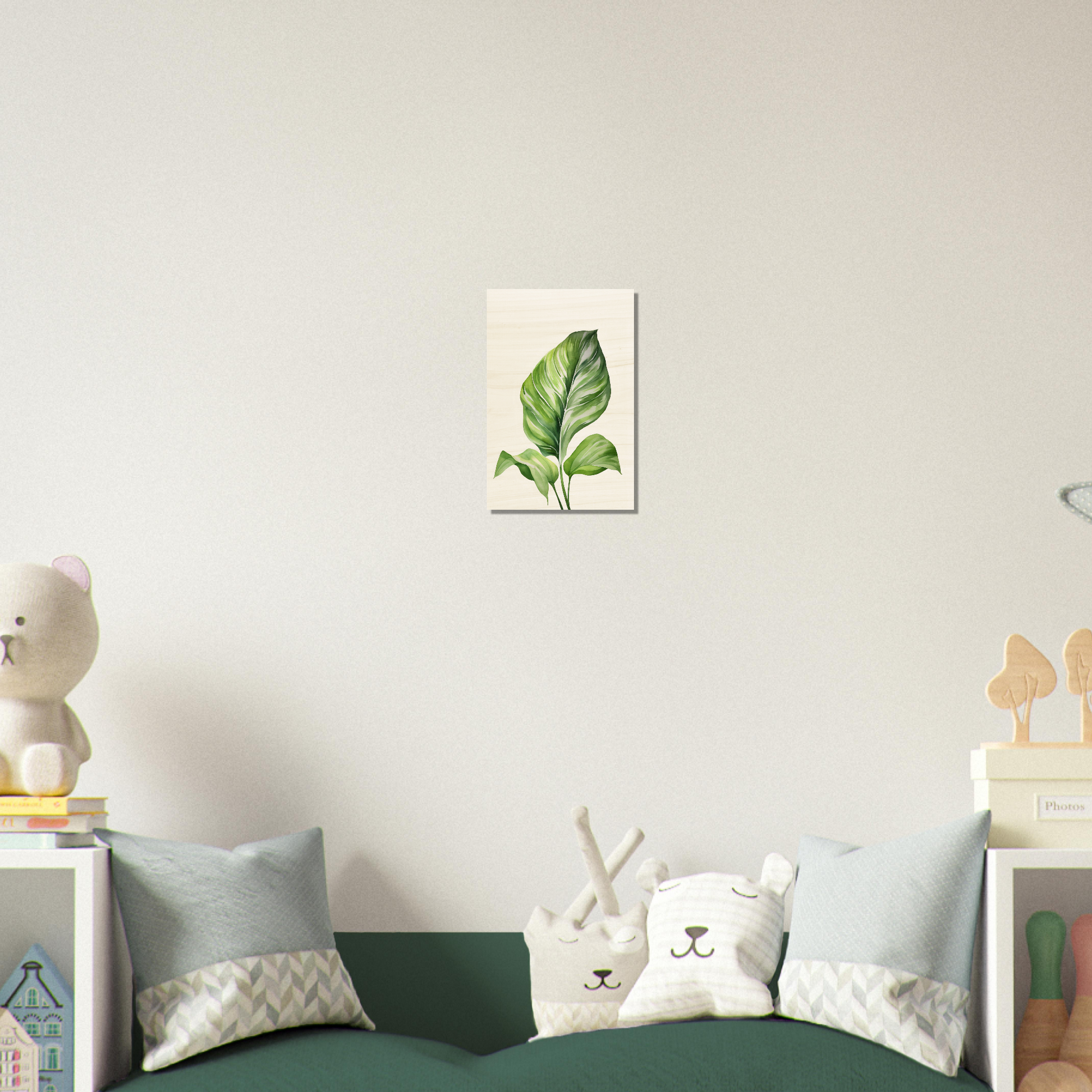 A green bed with a white pillow and a stuffed animal