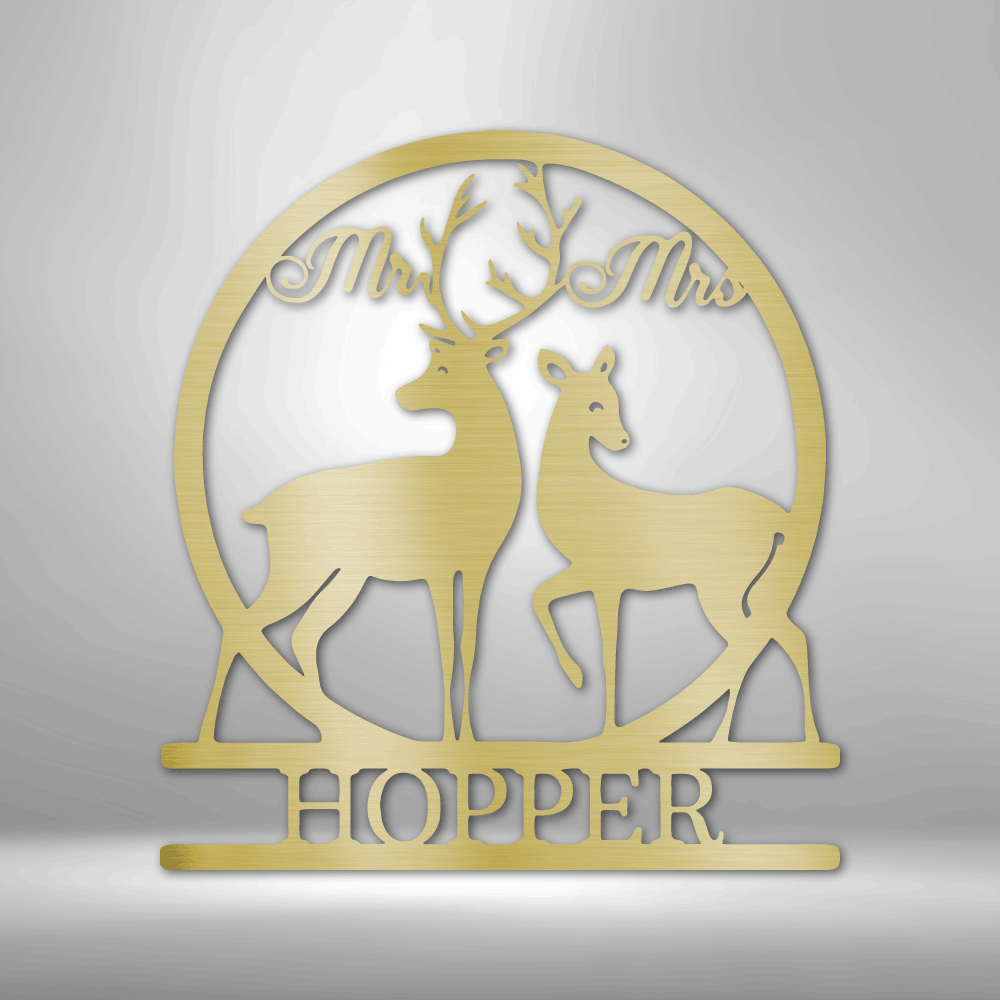 Gold-colored decorative wedding cake topper featuring two deer silhouettes and the text ’Mr & Mrs HOPPER’.