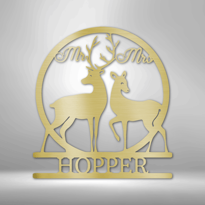 Gold-colored decorative wedding cake topper featuring two deer silhouettes and the text ’Mr & Mrs HOPPER’.