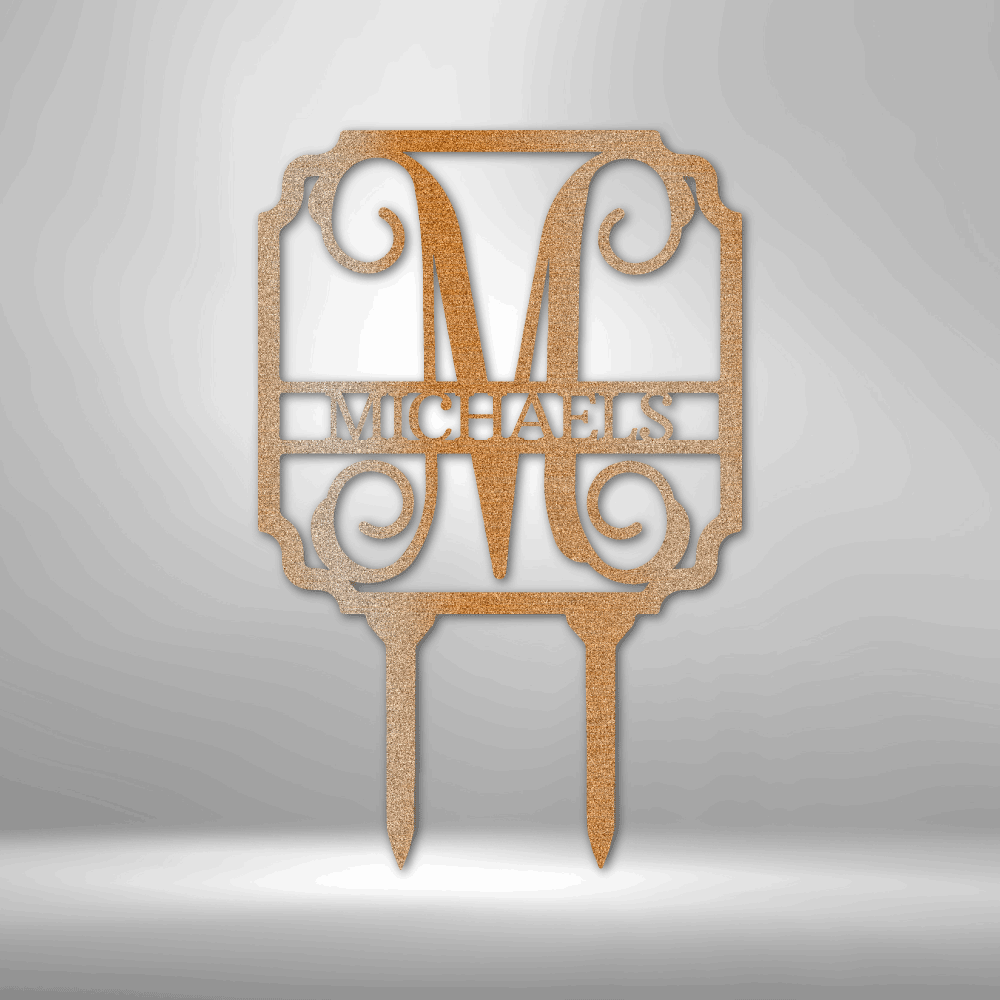 Decorative gold-colored cake topper featuring the letter ’M’ and the name ’MICHAELS’ in an ornate design.