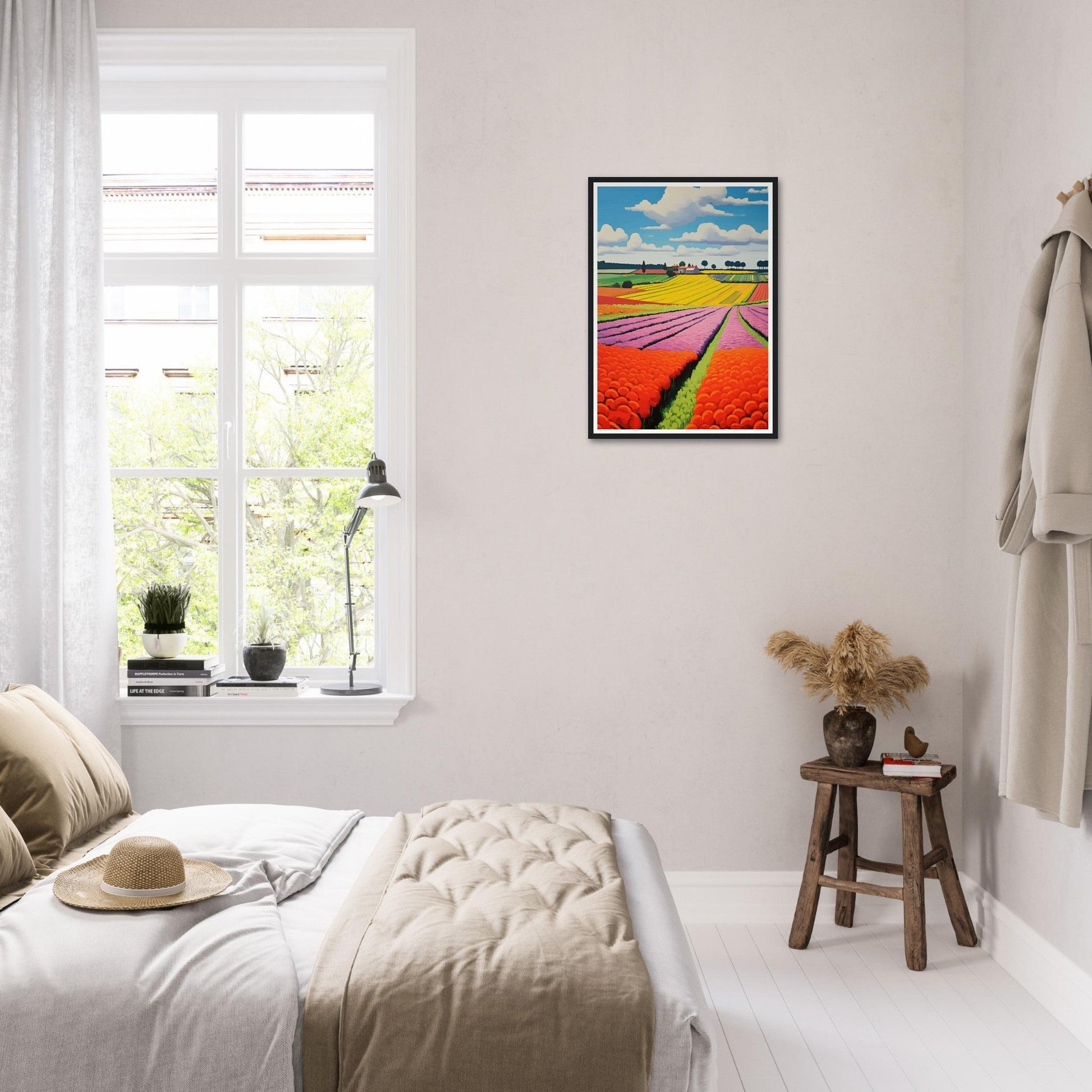 Bright, colorful framed artwork of tulip fields hanging on a white wall.