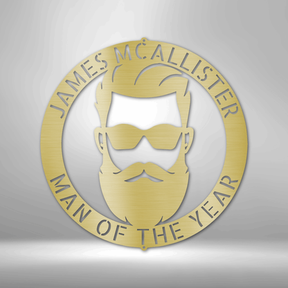 Gold circular emblem featuring a stylized bearded man’s face with sunglasses and the text ’James McAllister Man of the Year’.