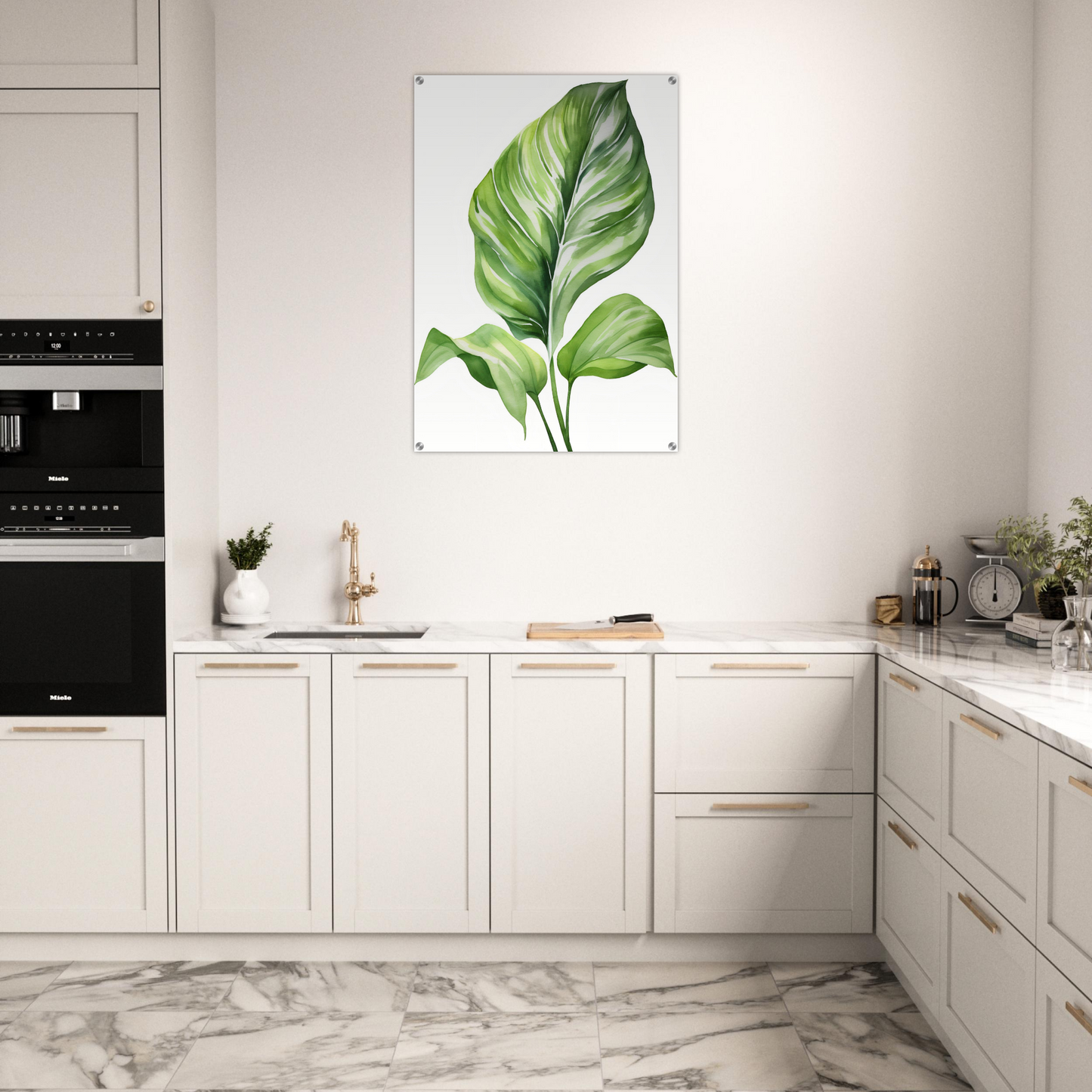 A kitchen with white cabinets and a large green leaf print on the wall