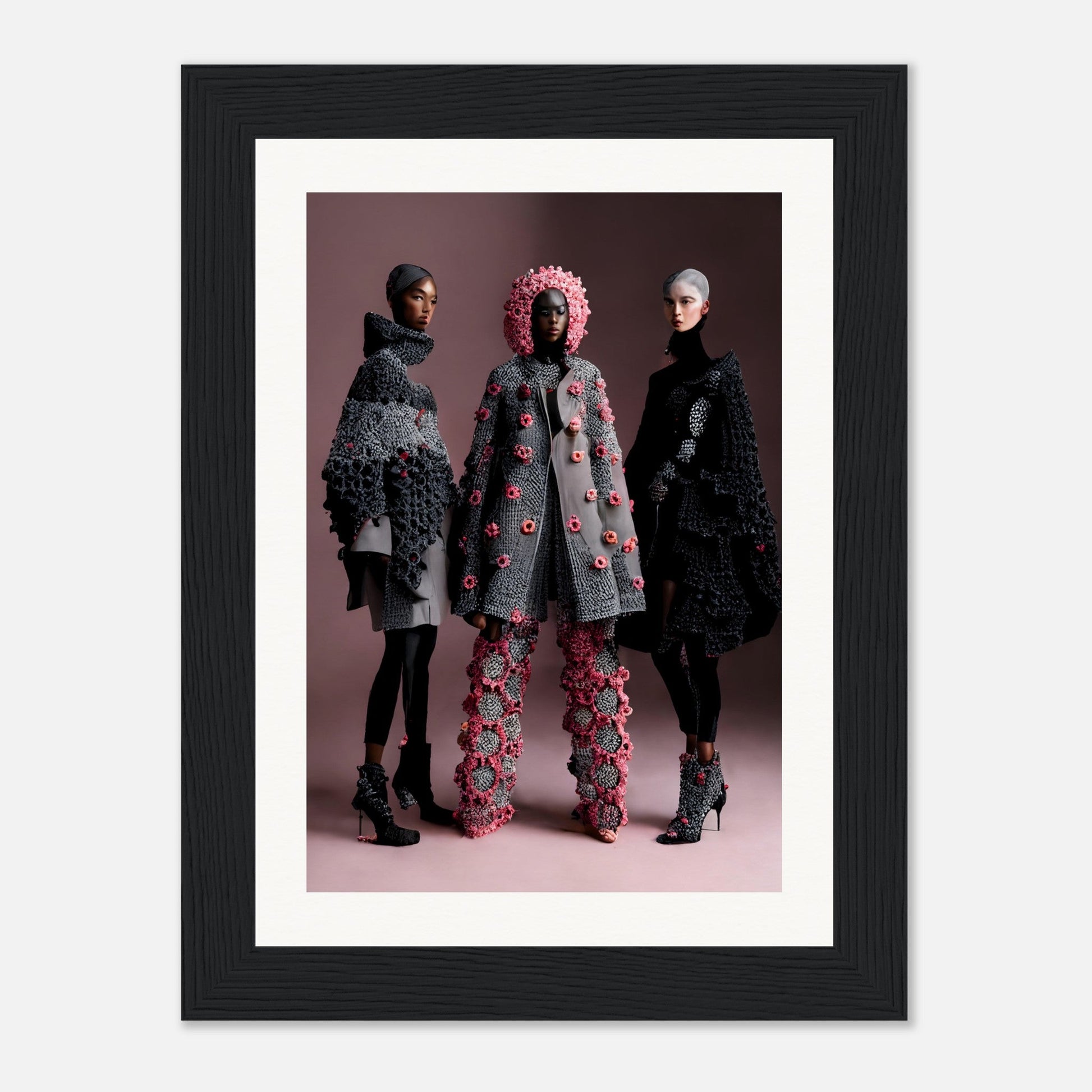 Framed photograph of three models wearing avant-garde floral-themed fashion designs.