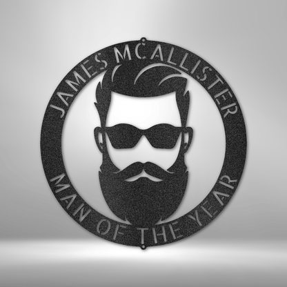Circular plaque featuring a stylized male face with sunglasses, beard, and text ’James McAllister Man of the Year’.