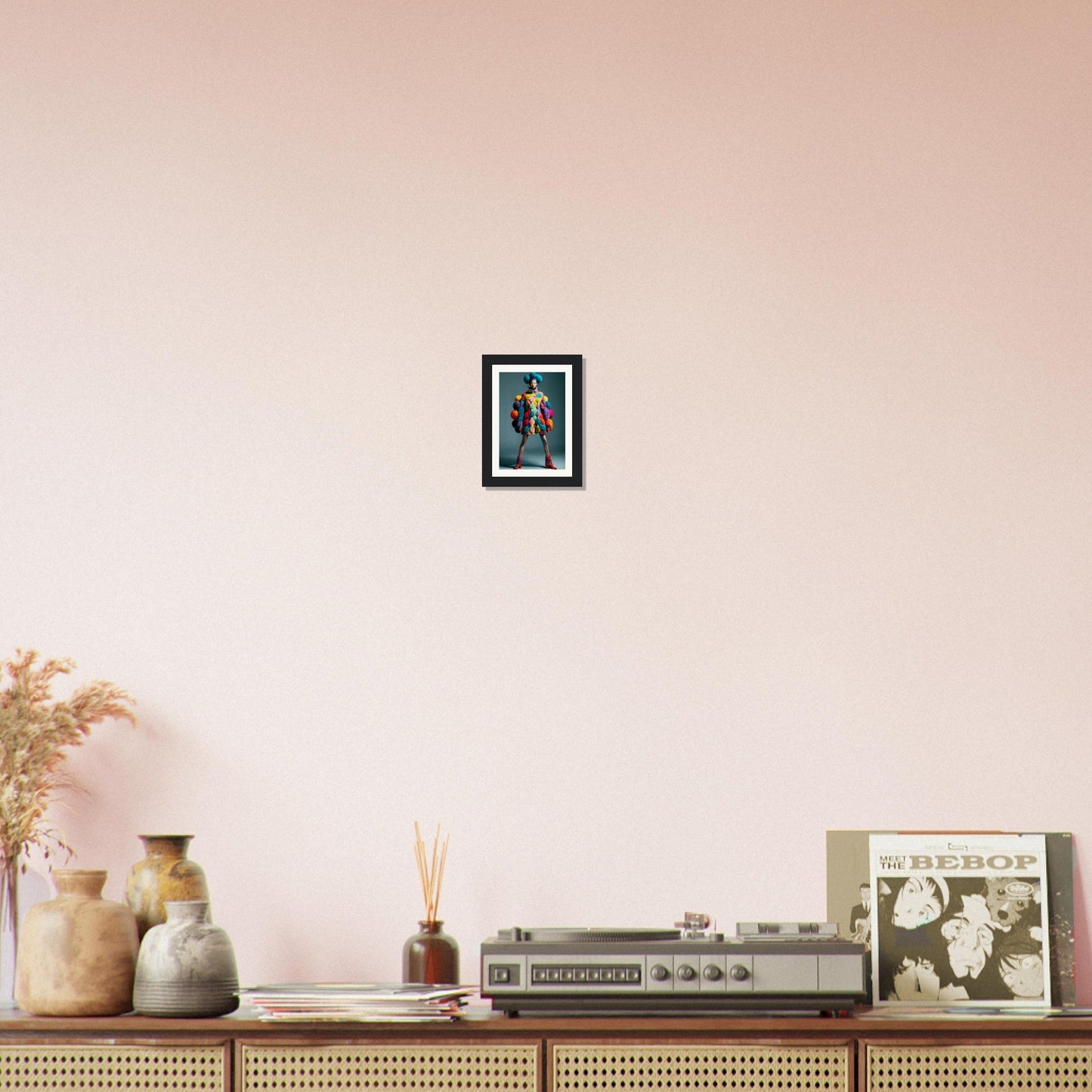 Framed artwork hanging on a pale pink wall.