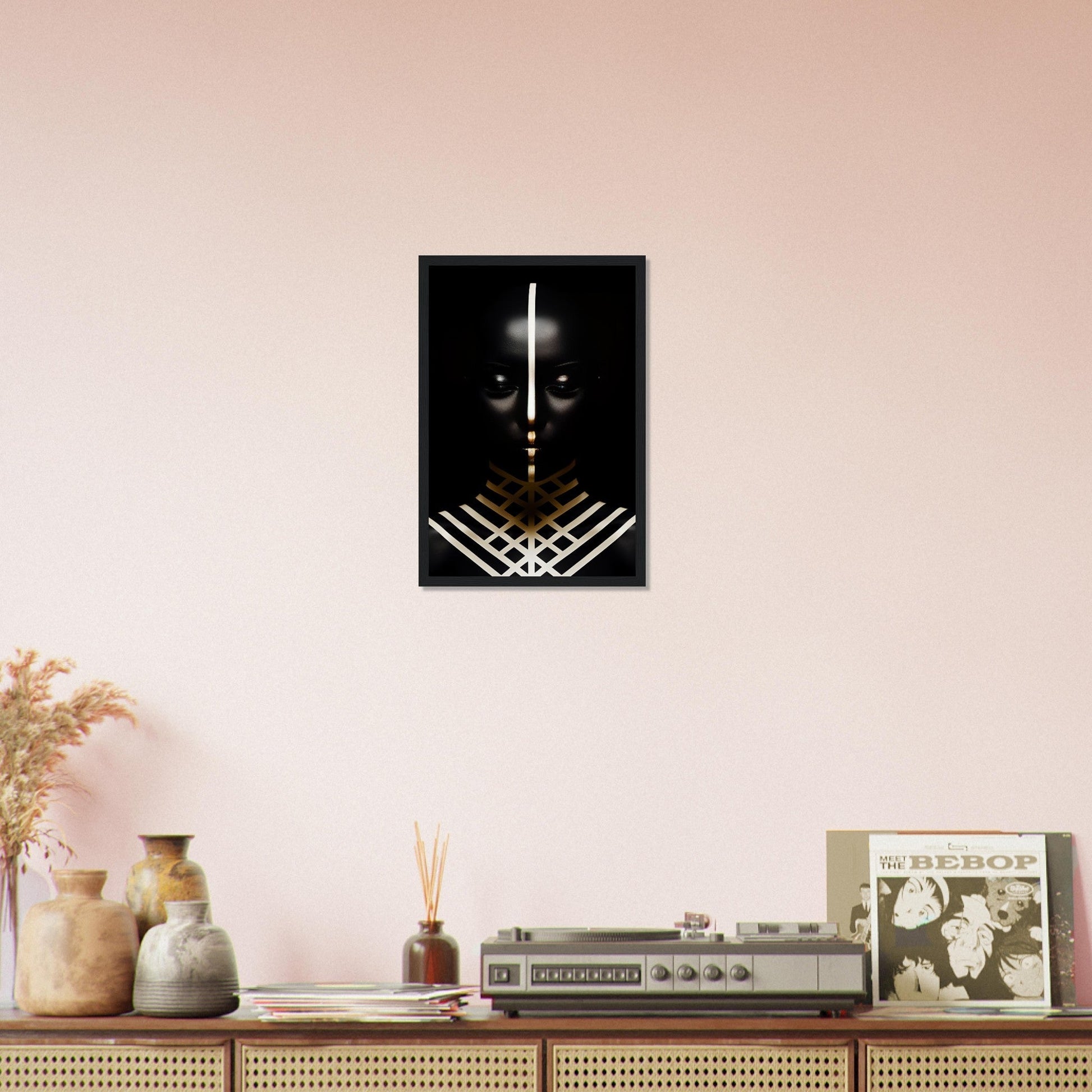 Framed black and white artwork featuring a stylized face with glowing eyes and geometric patterns.