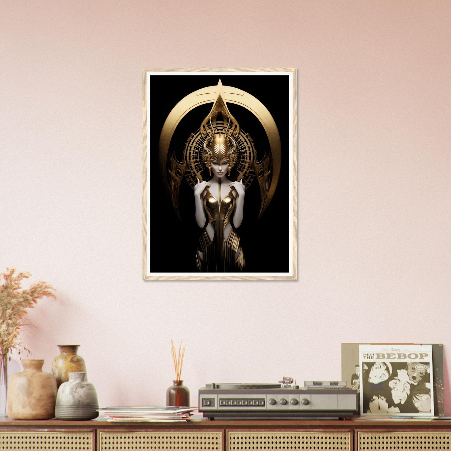 Framed artwork depicting a stylized golden figure with wings and an ornate headdress against a dark background.