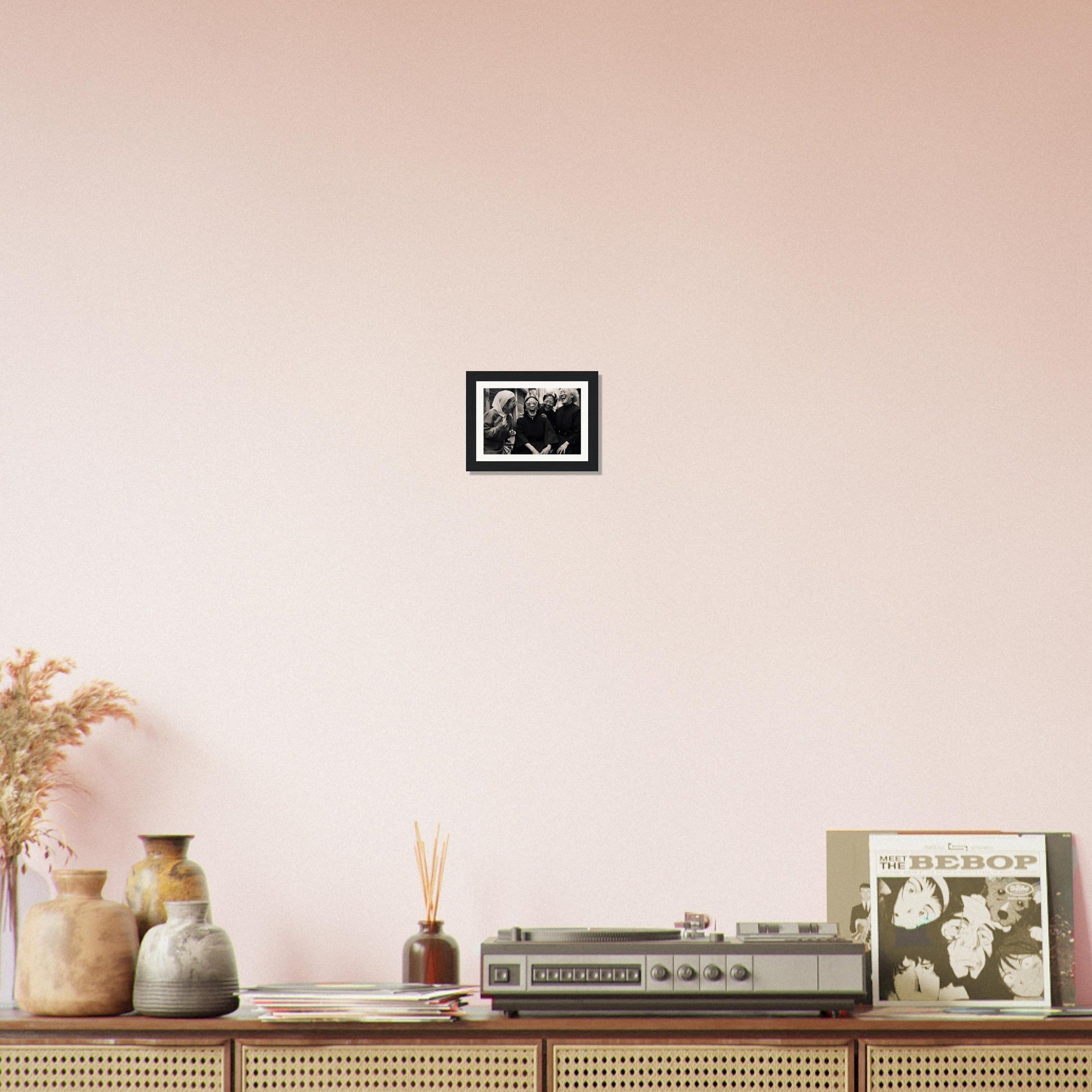 Wooden sideboard or console table with decorative items displayed on top, including vases, a vintage radio, and framed photographs.