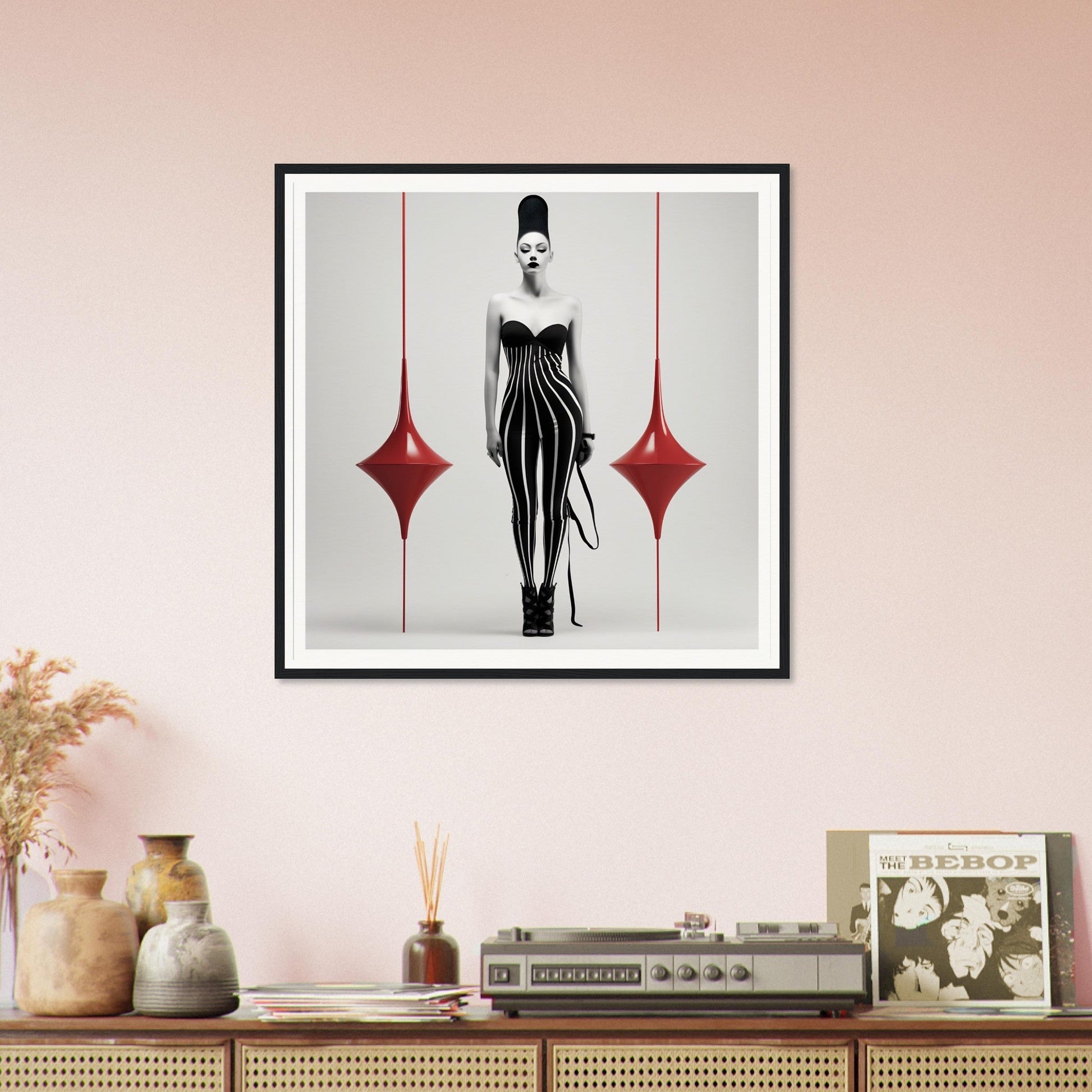 Framed artwork depicting a stylized figure in a striped bodysuit flanked by red diamond shapes.