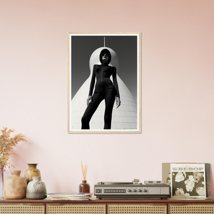 Black and white photograph of a silhouetted figure in a dramatic pose framed on a wall.