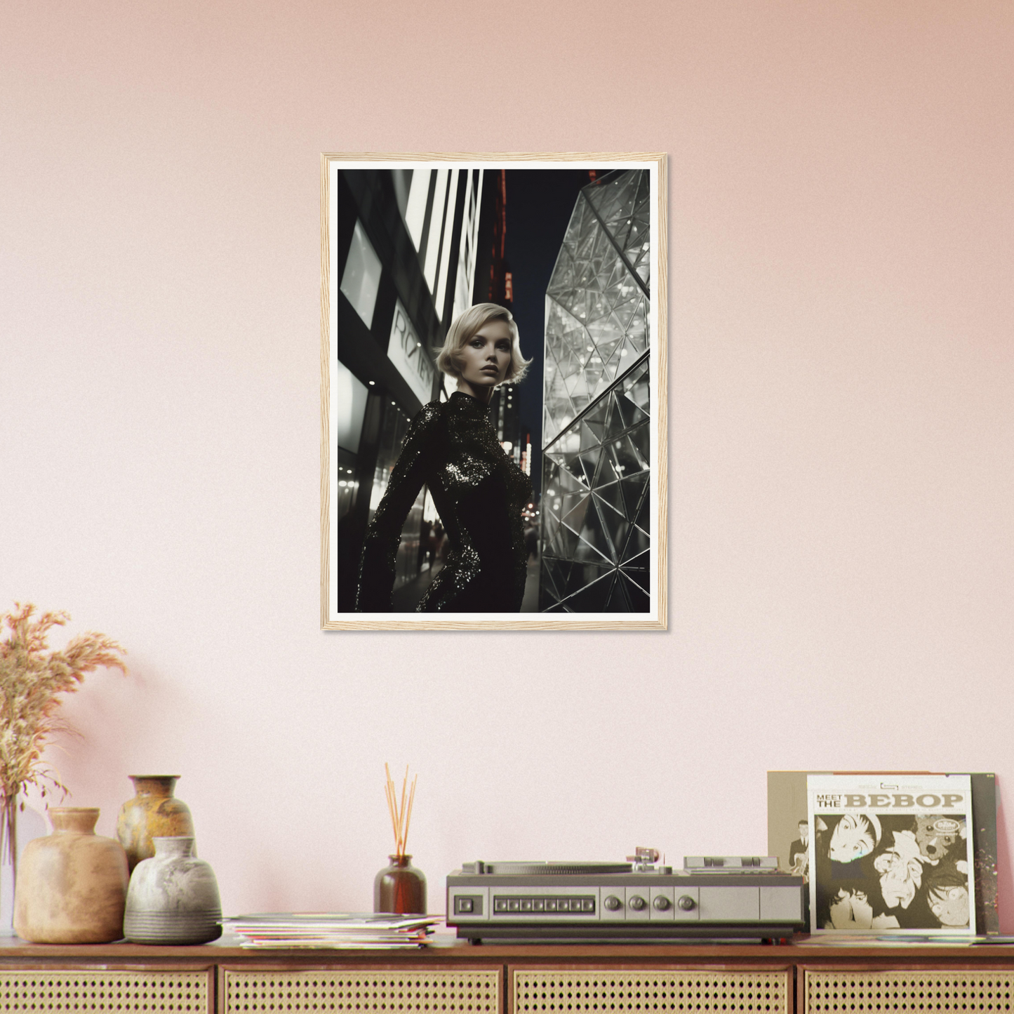 Framed black and white photograph hanging on a pale pink wall.