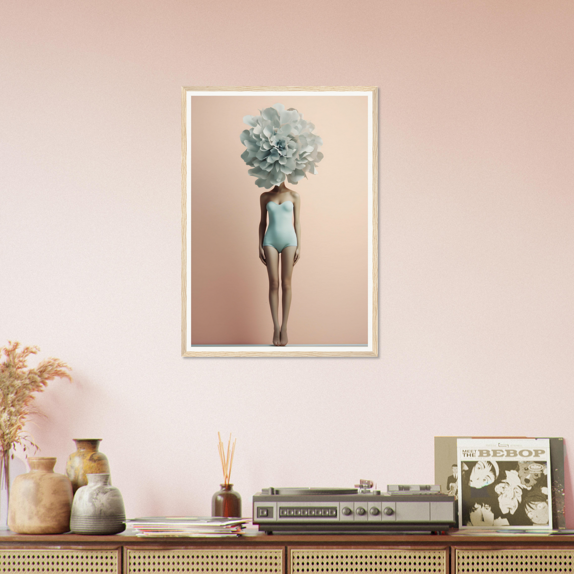 Framed artwork depicting a figure with a blue-green floral head wearing a pale blue swimsuit.