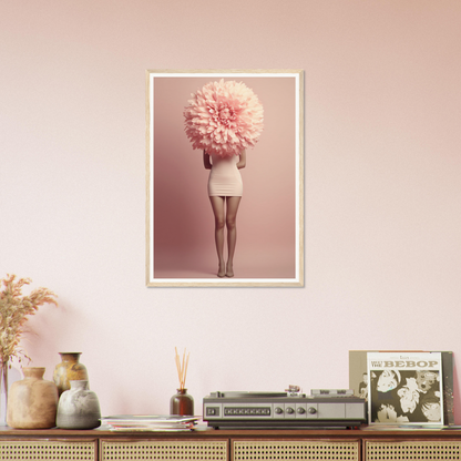 Framed photograph of a person with an oversized pink flower obscuring their head, wearing a white dress.