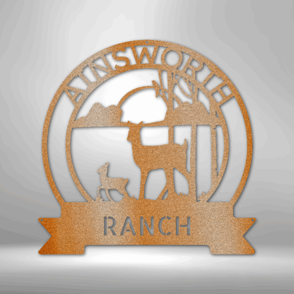 Circular metal sign featuring a ranch scene with deer silhouettes and the text ’AINSWORTH RANCH’.