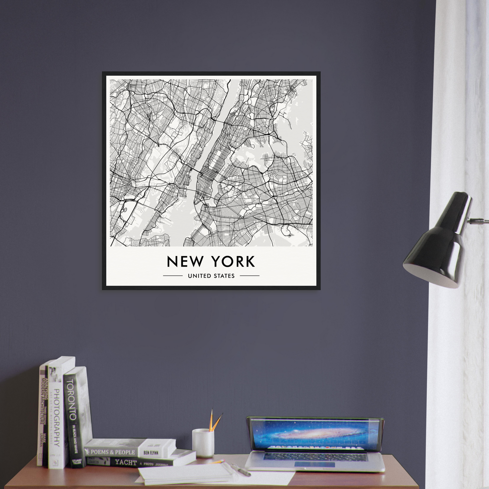 Framed map of New York City displayed on a dark wall.