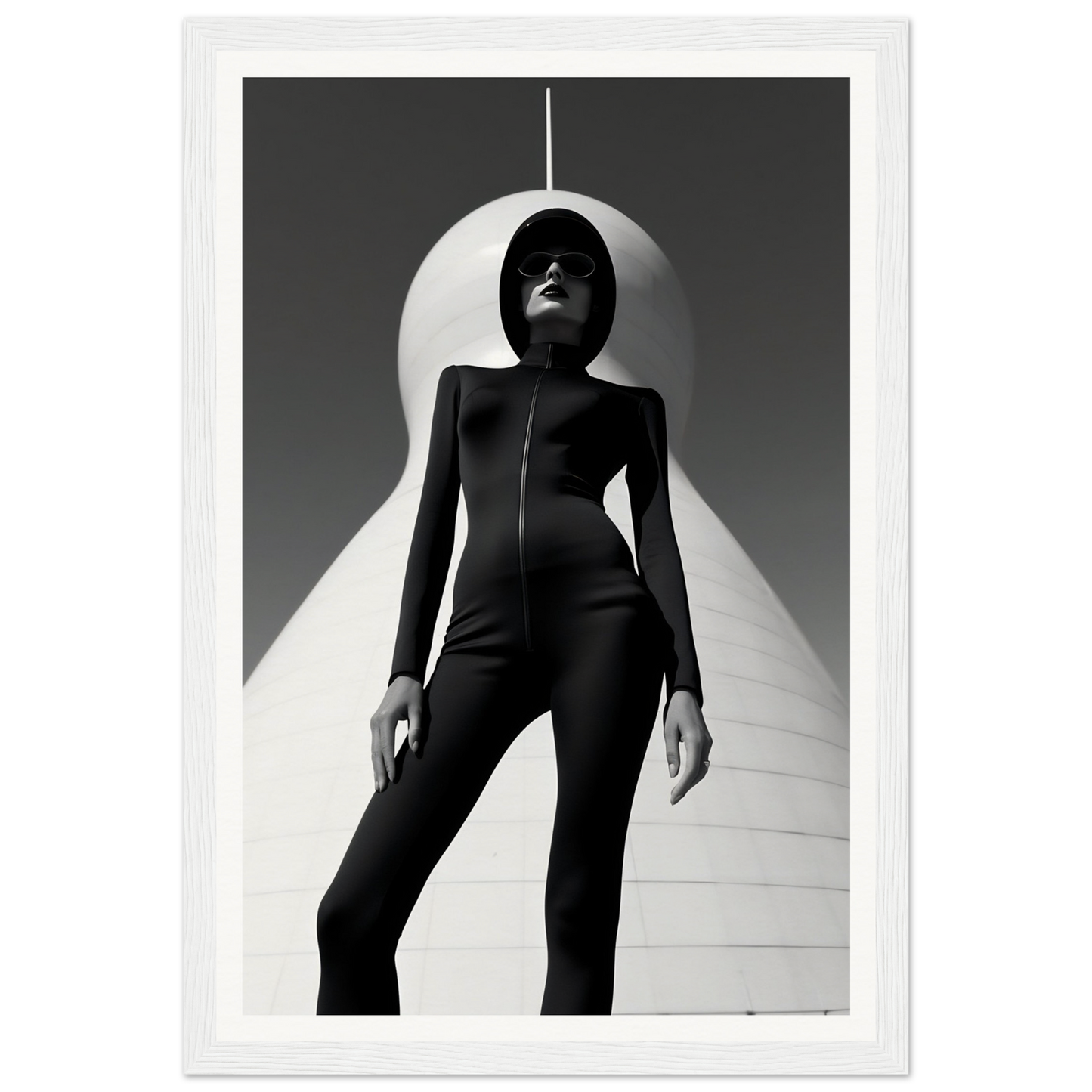 Silhouetted figure in a form-fitting black outfit standing dramatically against a stark white backdrop.