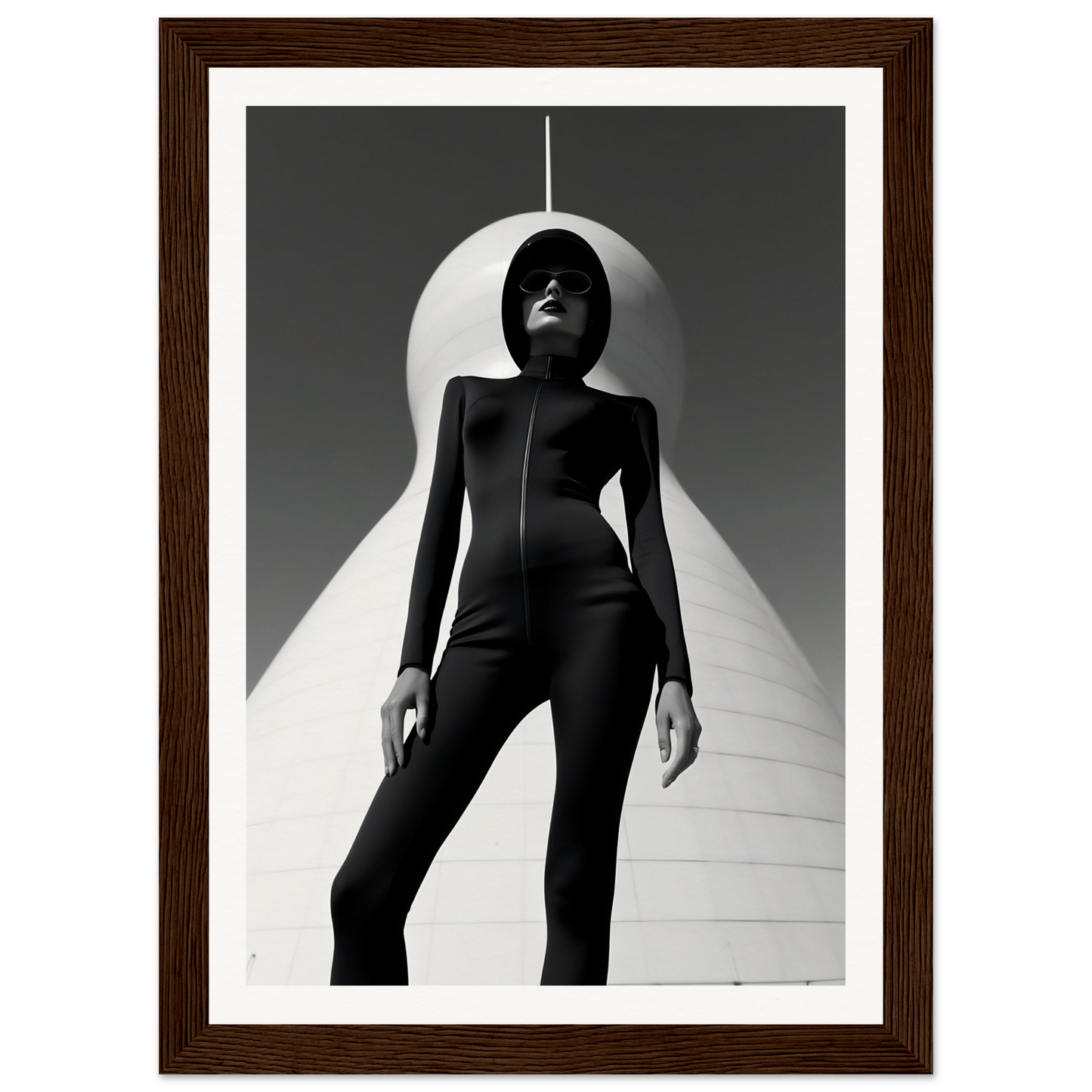 Silhouetted figure in a sleek black bodysuit striking a dramatic pose against a stark white backdrop.