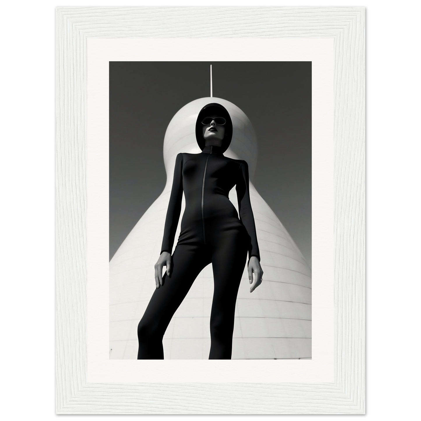 Silhouetted figure in a form-fitting black outfit standing beneath a curved white structure.